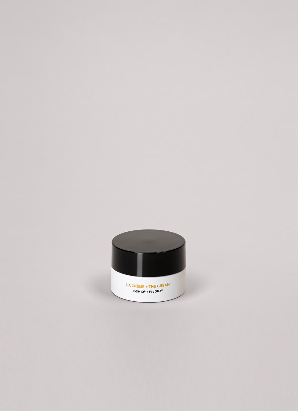Small black and white jar on a light gray background