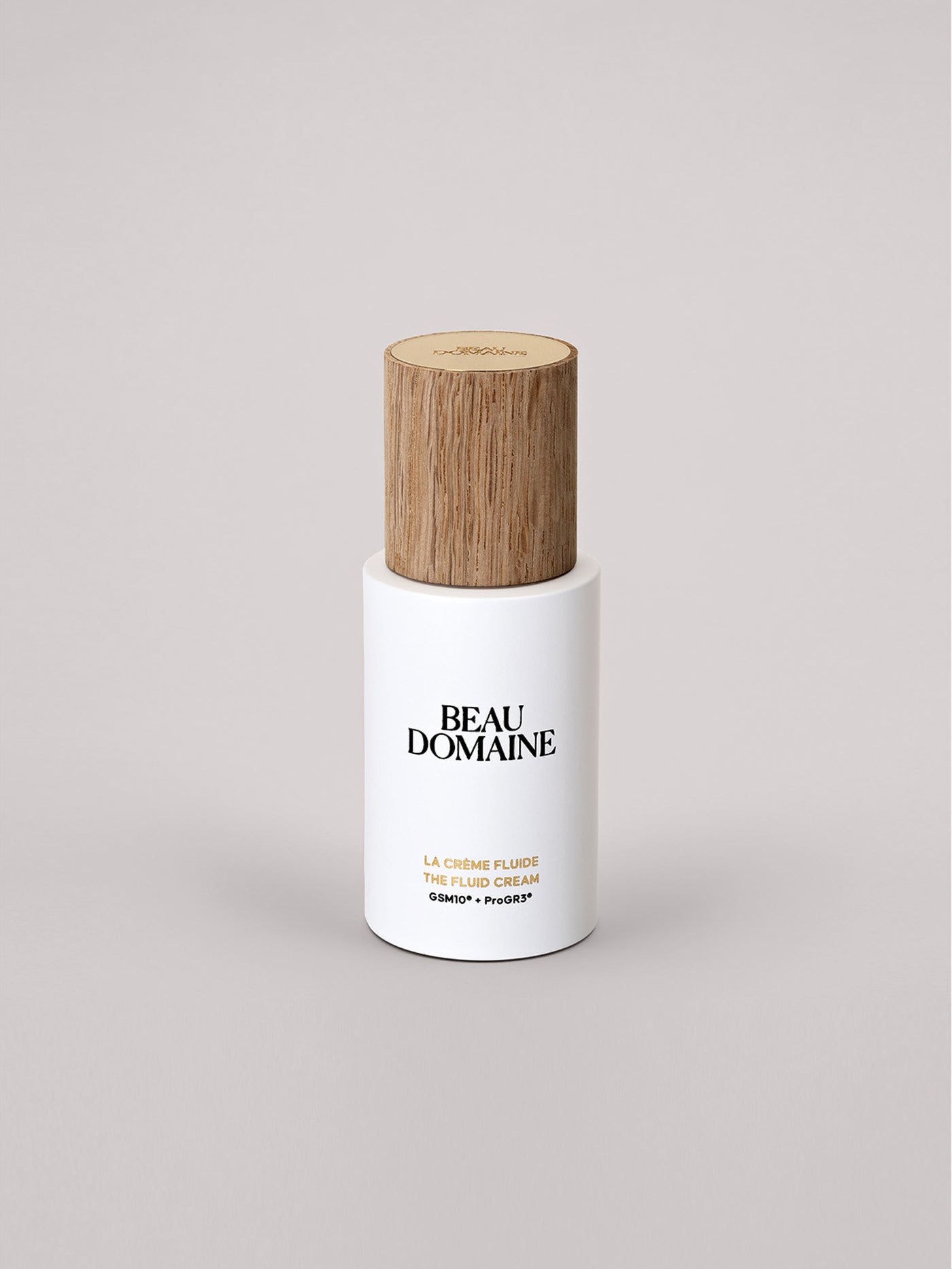Skincare bottle with wooden cap on a light gray background