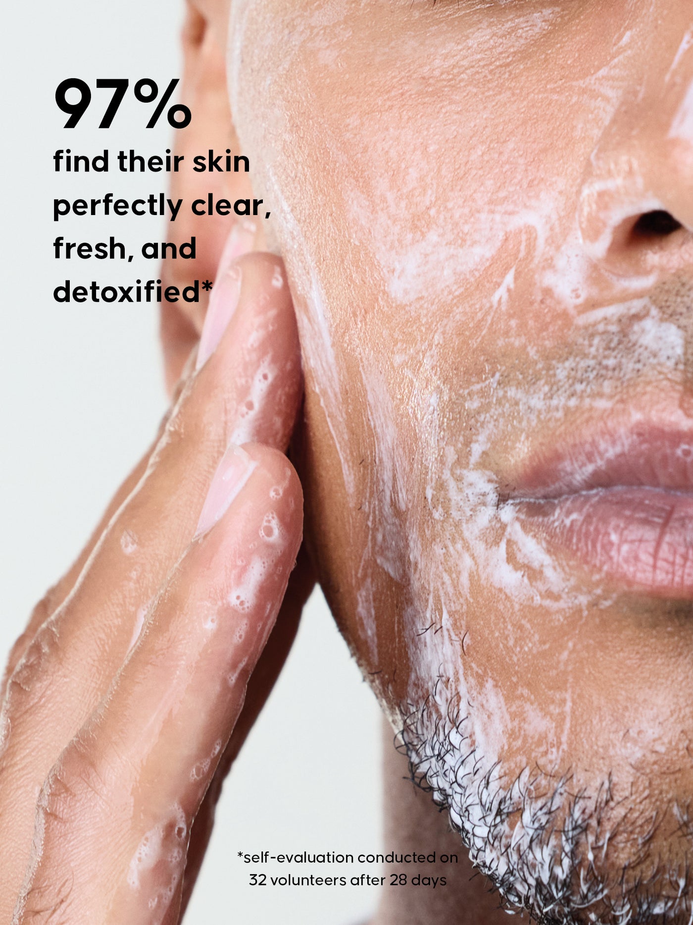 Close-up of a person applying a skincare product to their face with text about skin clarity and detoxification. 97% find their skin perfectly clear, fresh and detoxified.