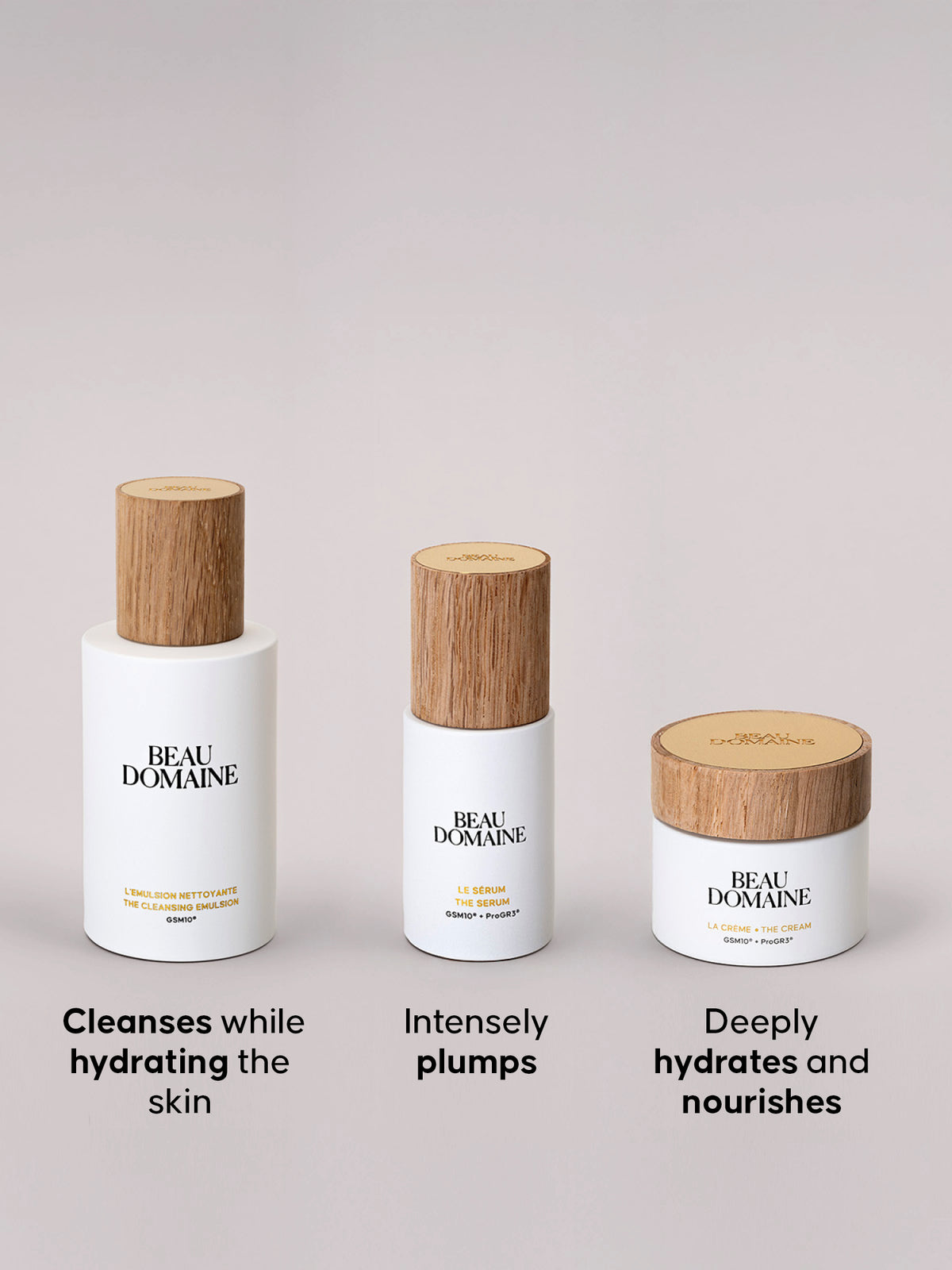 Three skincare products from BEAU DOMAINE on a light gray background